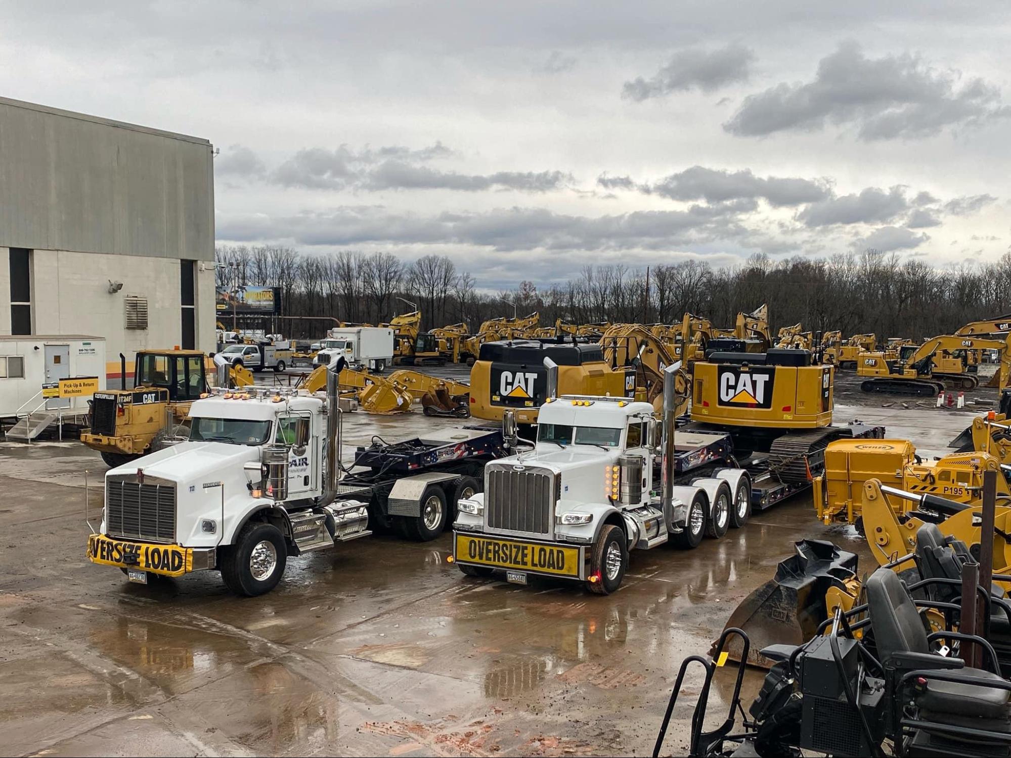 B. Blair trucks at CAT equipment dealer loading excavators