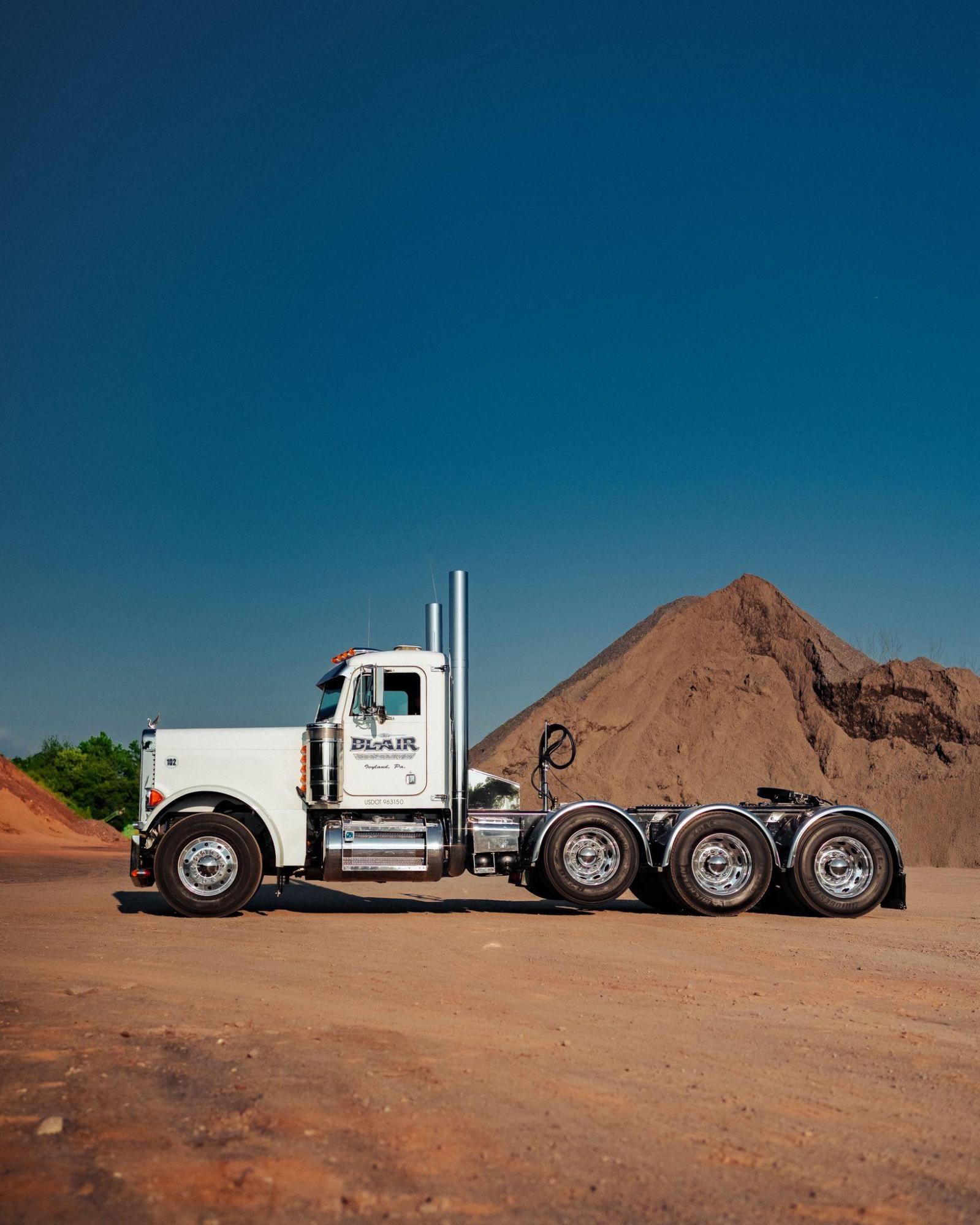 B. Blair Corporation Peterbilt truck at quarry, deep blue sky