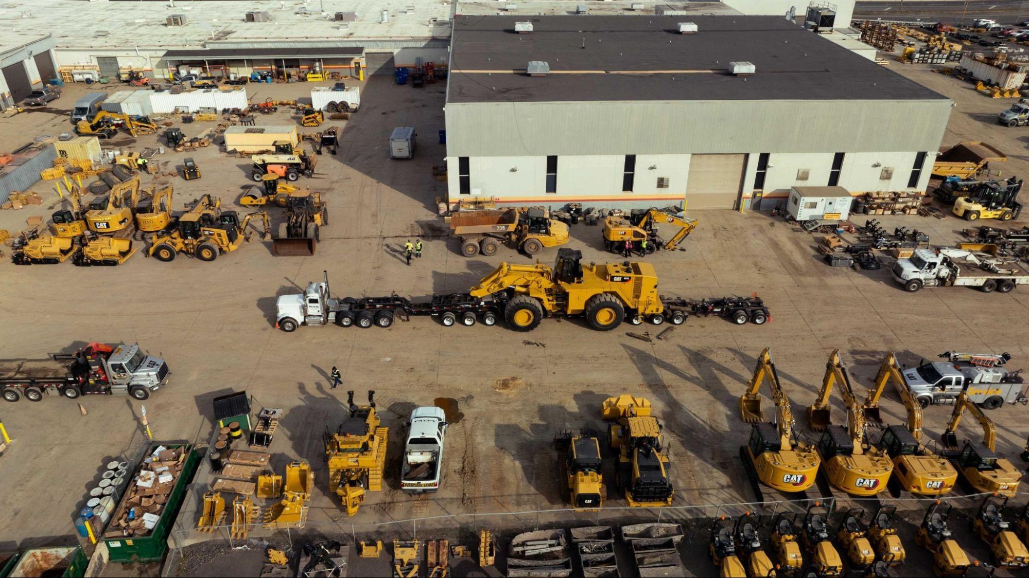 Aerial view of heavy equipment yard with B. Blair truck loading wheel loader