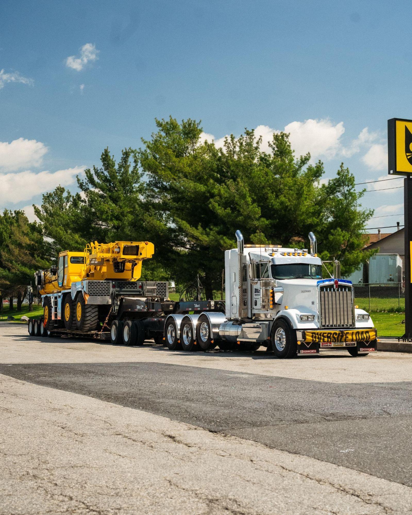 B. Blair Kenworth oversize load transporting yellow crane on lowboy